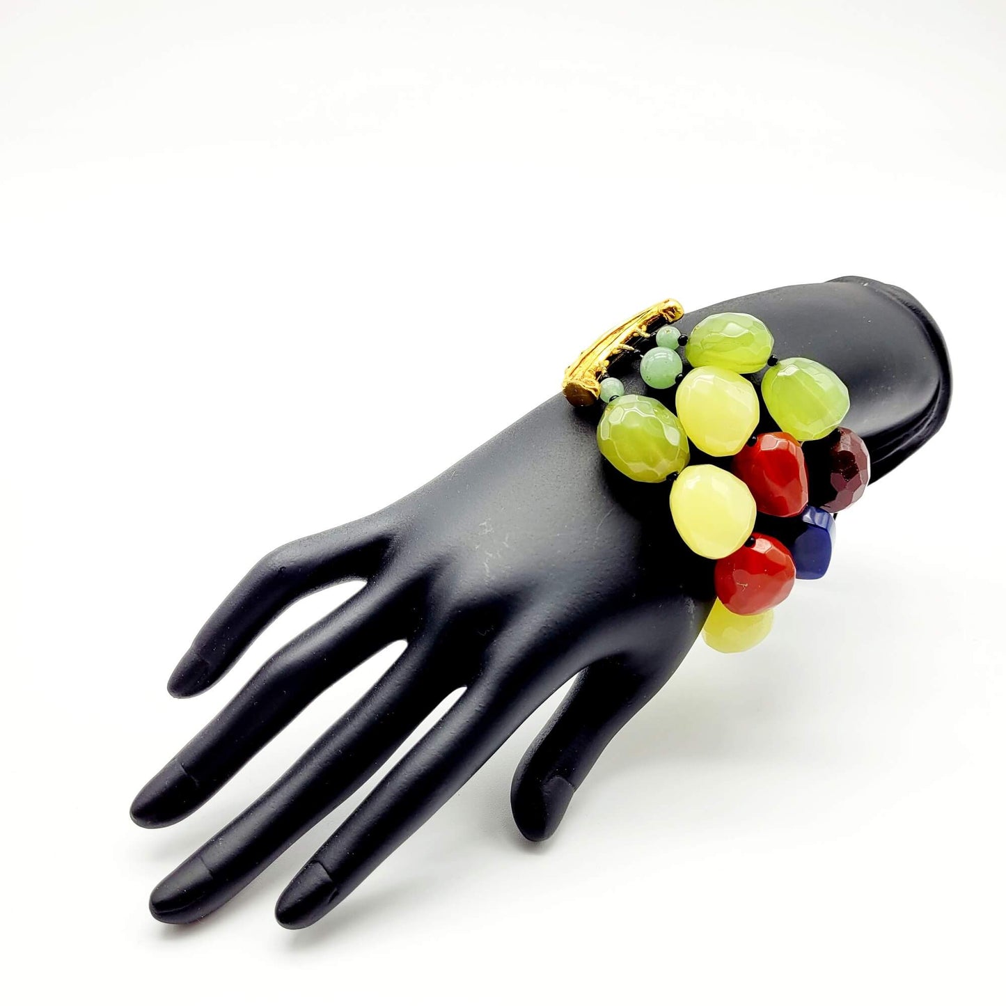 A vintage bracelet with colorful oversized beads on a black mannequin hand
